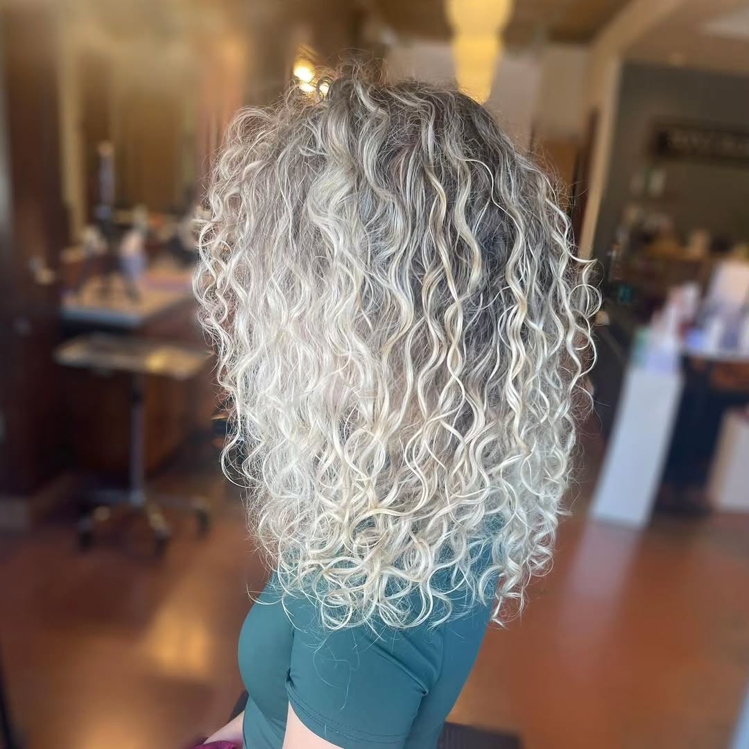 Curly silver hair color and styling in Houston Heights